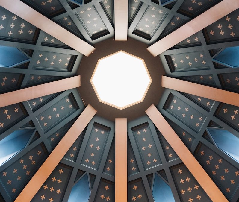 Octagonal ceiling with radiating beams and windows.